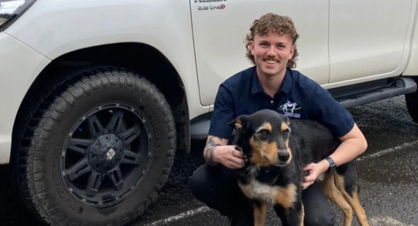 Callum next to his vehicle with Alfie, his dog